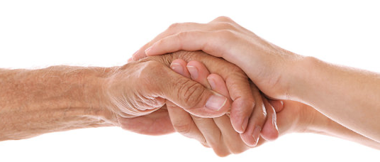 Two young adult hands clasping an older person's hand
