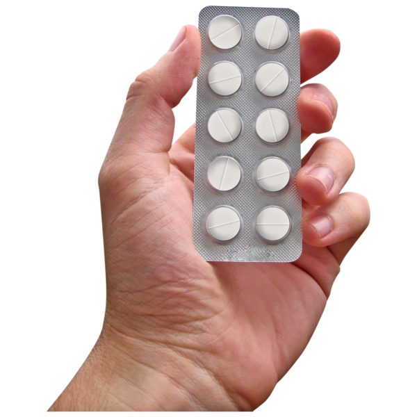 A left hand holding a blister pack of 10 white tablets