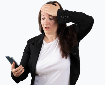 Person looking shocked at their mobile phone, with one hand on their forehead and the other holding the phone