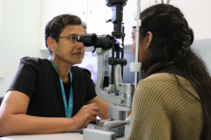 Consultant eye testing a patient