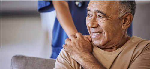 Patient being comforted by NHS worker, who is putting a hand on the patient's shoulder