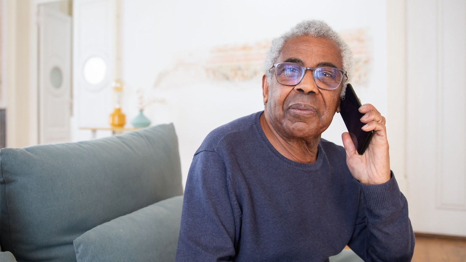 Person sitting on a seat speaking on the phone