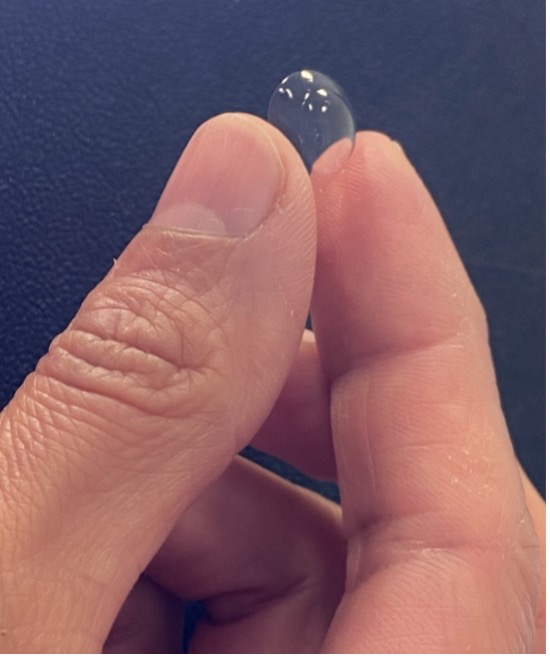 Fingers Holding Contact Lens