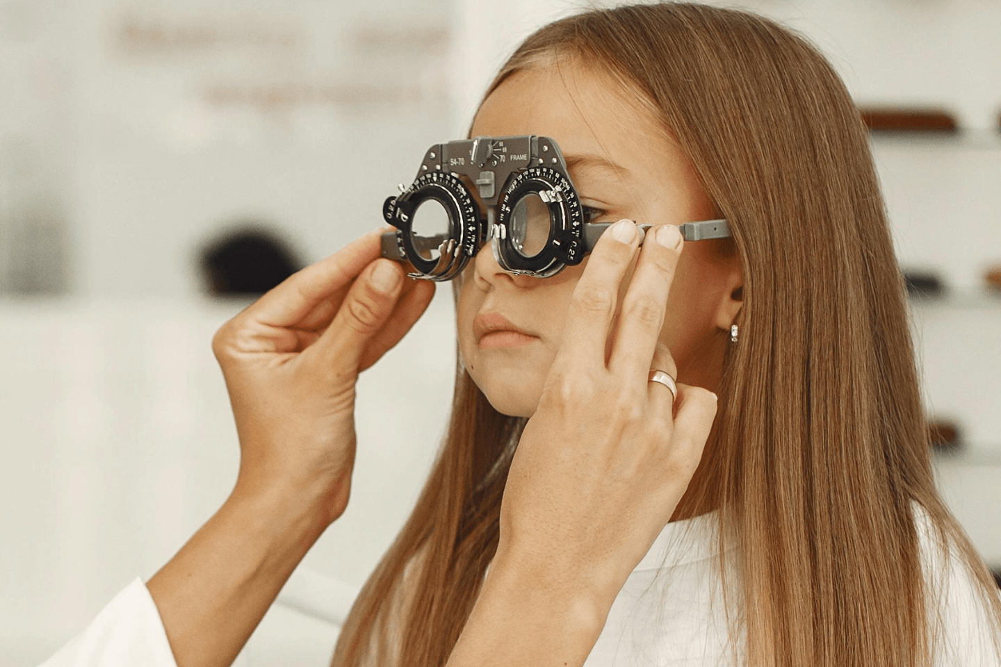 Ophthalmologist examining a child's eyes using medical equipment
