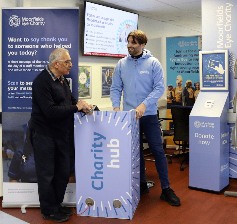 Two people talking at the City Road charity hub